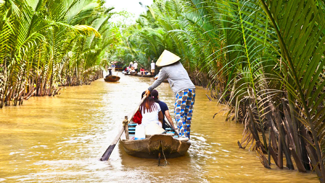 A boat trip through the water coconuts in the Mekong Delta--Vietnam Cambodia 12 Days Highlights Tour